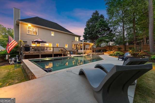 view of pool featuring a patio area, a deck, a fenced backyard, a fenced in pool, and a sunroom