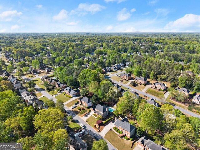 bird's eye view featuring a view of trees and a residential view