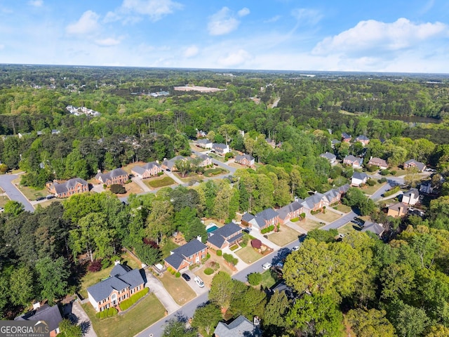 bird's eye view featuring a residential view and a wooded view