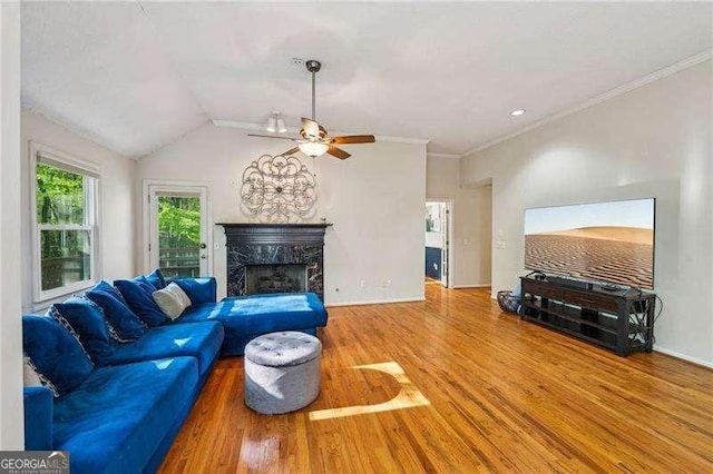 230 Oakmere Dr, Alpharetta, GA 30009 - living area with crown molding, a fireplace, a ceiling fan, wood finished floors, and baseboards
