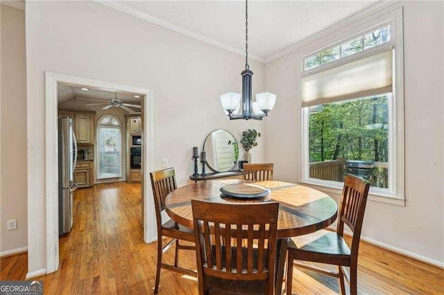 230 Oakmere Dr, Alpharetta, GA 30009 - dining area featuring crown molding, baseboards, light wood-type flooring, and ceiling fan with notable chandelier