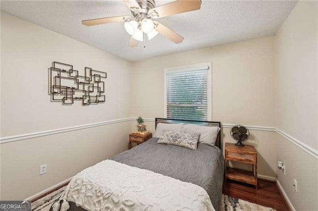 230 Oakmere Dr, Alpharetta, GA 30009 - bedroom featuring a textured ceiling, wood finished floors, baseboards, and a ceiling fan