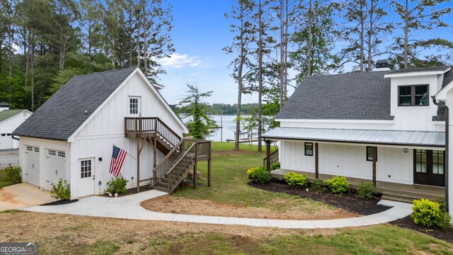 1001 Sugar Hill Way, Buckhead, GA 30625 - modern farmhouse style home featuring a porch, board and batten siding, roof with shingles, a water view, and stairs