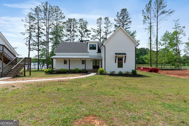 1001 Sugar Hill Way, Buckhead, GA 30625 - modern farmhouse style home featuring stairs, board and batten siding, covered porch, and a front yard
