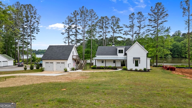 1001 Sugar Hill Way, Buckhead, GA 30625 - modern farmhouse style home featuring board and batten siding, an outdoor structure, a front lawn, concrete driveway, and a water view