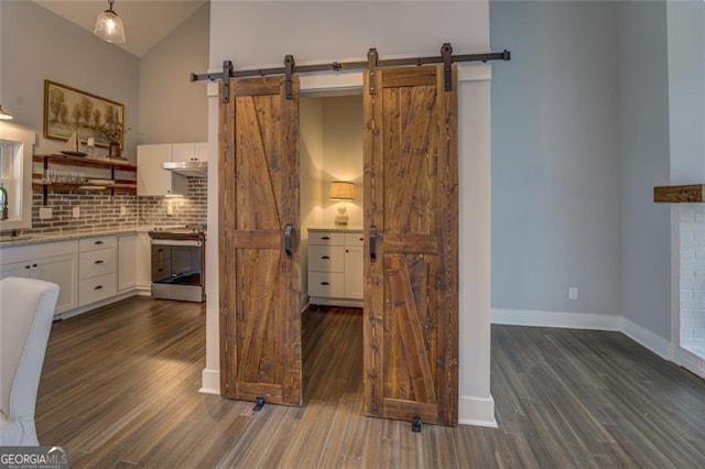 1001 Sugar Hill Way, Buckhead, GA 30625 - kitchen with stainless steel electric stove, tasteful backsplash, a barn door, and white cabinetry