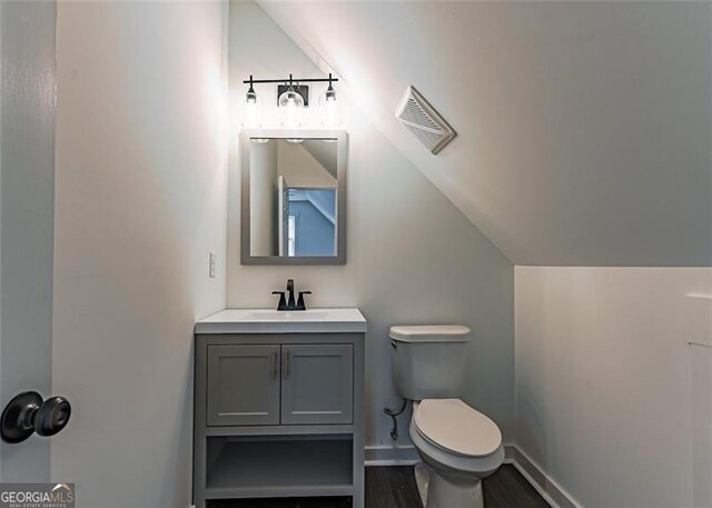1001 Sugar Hill Way, Buckhead, GA 30625 - half bath with lofted ceiling, toilet, wood finished floors, and visible vents