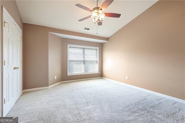 unfurnished room featuring light carpet, baseboards, a ceiling fan, and lofted ceiling