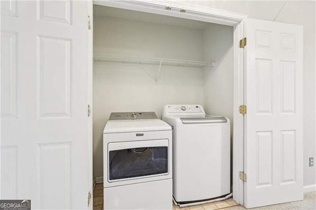 clothes washing area featuring washer and dryer and laundry area