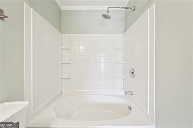 bathroom with toilet, crown molding, and shower / tub combination