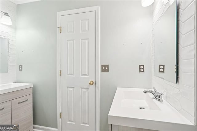 bathroom featuring vanity and backsplash