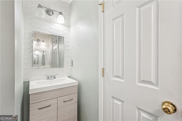 bathroom featuring vanity and decorative backsplash