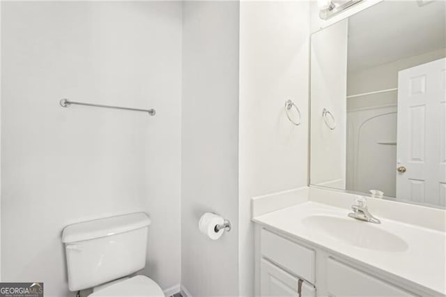 bathroom with toilet and vanity