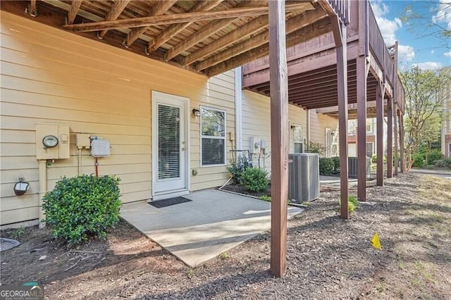 property entrance with cooling unit and a patio area