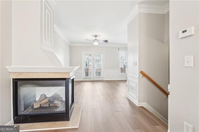 corridor featuring an upstairs landing, crown molding, and wood finished floors