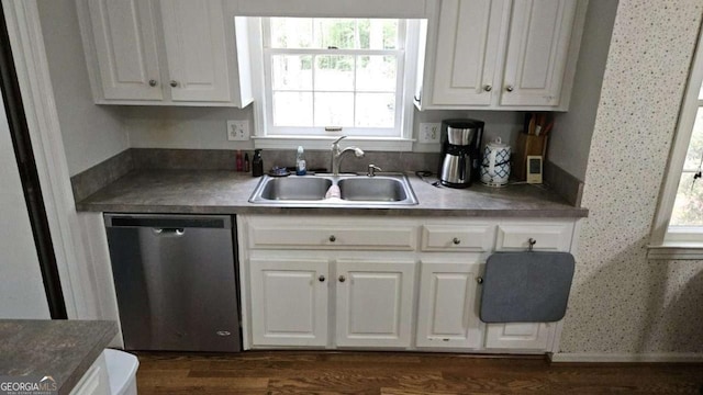 kitchen featuring stainless steel dishwasher, dark wood-type flooring, white cabinets, and a sink
