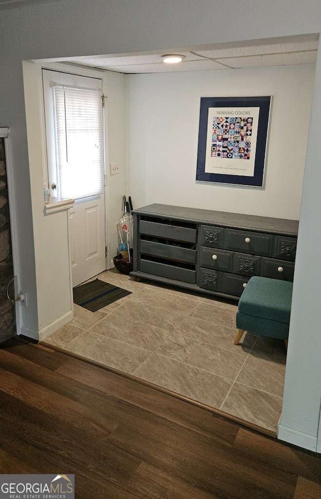 foyer featuring baseboards and wood finished floors