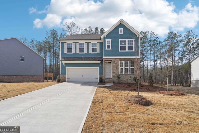 view of front of property featuring concrete driveway, a front lawn, stone siding, and an attached garage