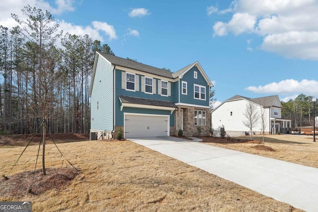 view of front facade featuring a front yard, a garage, and concrete driveway