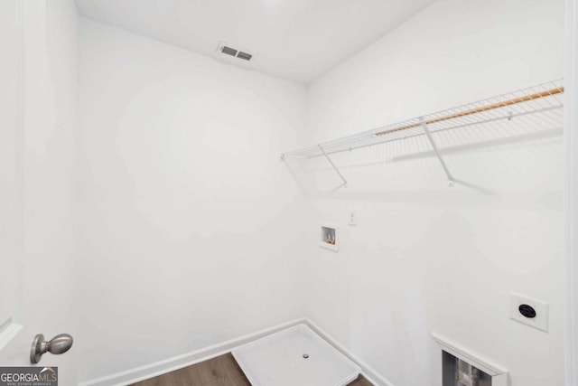 clothes washing area featuring electric dryer hookup, visible vents, laundry area, hookup for a washing machine, and wood finished floors