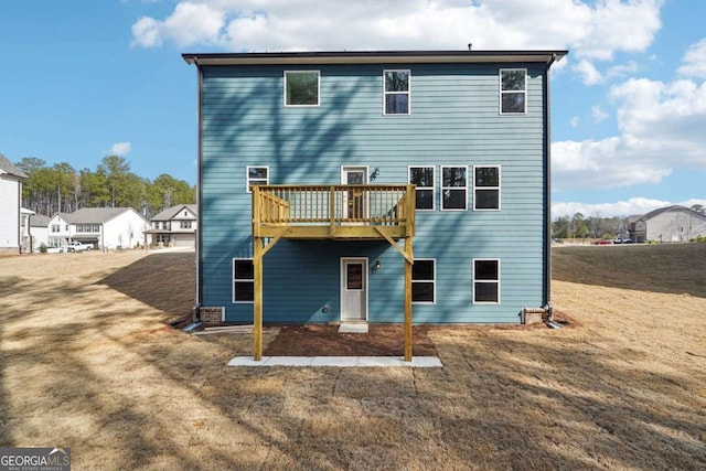 back of property featuring a yard and a deck