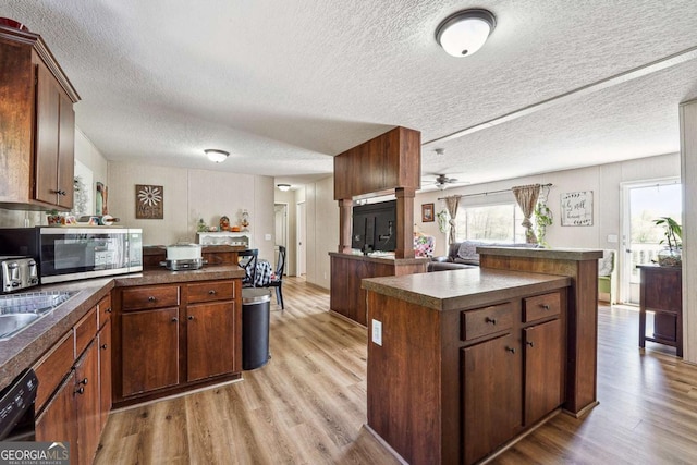 2496 Venture Dr, Gainesville, GA 30506 - kitchen featuring light wood-type flooring, stainless steel microwave, ceiling fan, and a textured ceiling