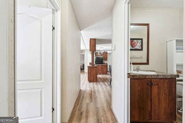 2496 Venture Dr, Gainesville, GA 30506 - hall featuring a sink, light wood-style flooring, and a textured ceiling