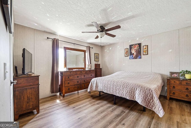 2496 Venture Dr, Gainesville, GA 30506 - bedroom with a textured ceiling, wood finished floors, and a ceiling fan