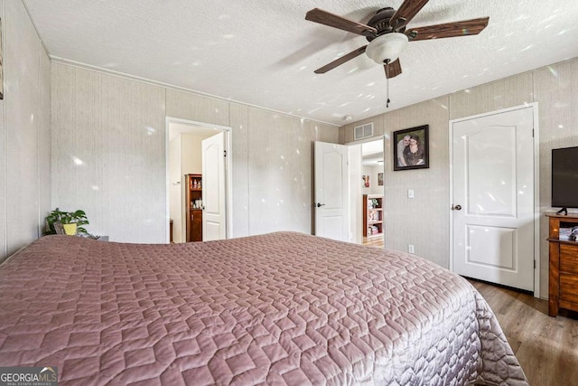 2496 Venture Dr, Gainesville, GA 30506 - bedroom with visible vents, a ceiling fan, wood finished floors, and a textured ceiling