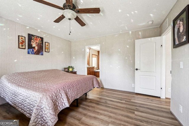 2496 Venture Dr, Gainesville, GA 30506 - bedroom with ensuite bathroom, ceiling fan, and wood finished floors