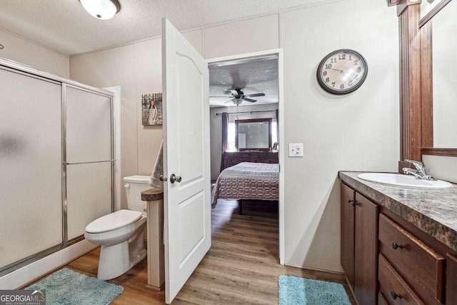 2496 Venture Dr, Gainesville, GA 30506 - ensuite bathroom featuring toilet, a textured ceiling, vanity, wood finished floors, and a stall shower