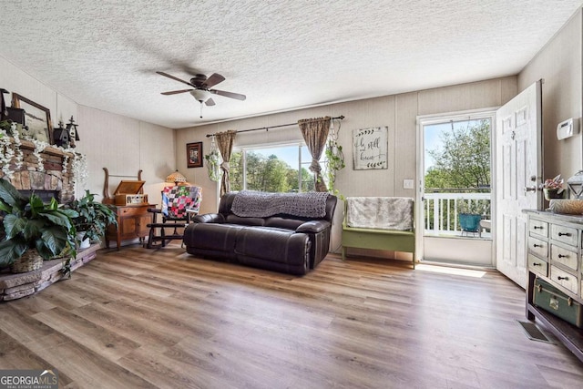 2496 Venture Dr, Gainesville, GA 30506 - living area with a healthy amount of sunlight, wood finished floors, and ceiling fan