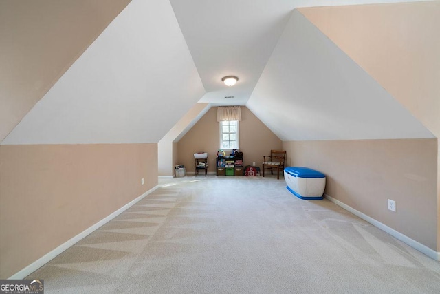 additional living space featuring baseboards, carpet, and vaulted ceiling