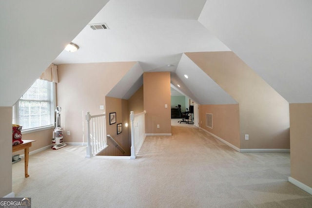 bonus room featuring visible vents, carpet floors, baseboards, and vaulted ceiling