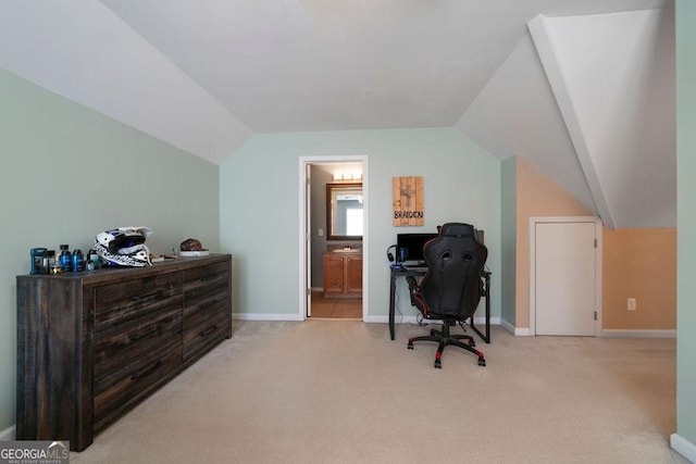 carpeted home office with baseboards and lofted ceiling