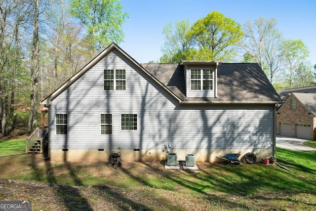 back of property featuring crawl space, cooling unit, and a lawn