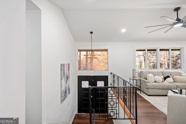 entryway featuring recessed lighting, vaulted ceiling, wood finished floors, and ceiling fan with notable chandelier