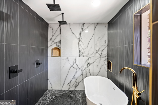 full bath featuring tile walls, a tile shower, and a soaking tub