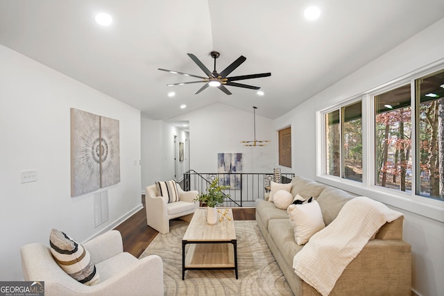 living room with recessed lighting, ceiling fan with notable chandelier, wood finished floors, and lofted ceiling