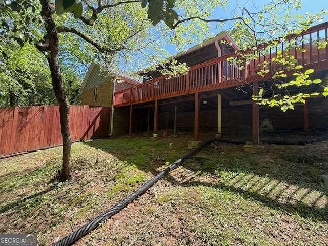 view of yard featuring a deck and fence