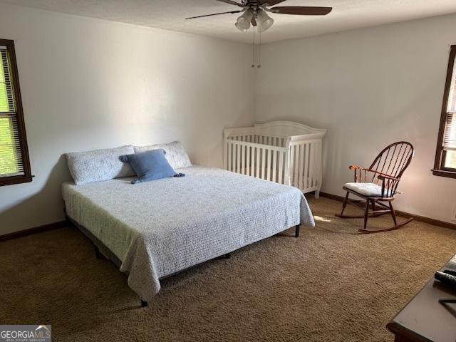bedroom with carpet floors, baseboards, and a ceiling fan