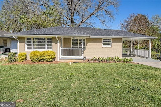 single story home with a porch, a carport, a front yard, brick siding, and driveway
