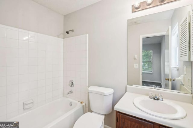 full bathroom with toilet, vanity, and washtub / shower combination