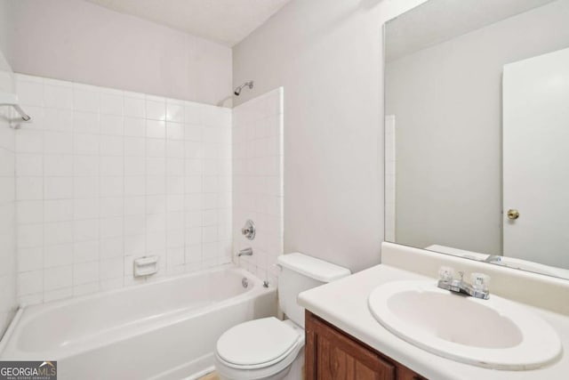 bathroom with toilet, vanity, and shower / bathtub combination