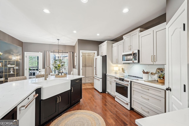 185 Starlight Dr, Dahlonega, GA 30533 - kitchen with dark wood-style flooring, recessed lighting, white appliances, decorative light fixtures, and a sink