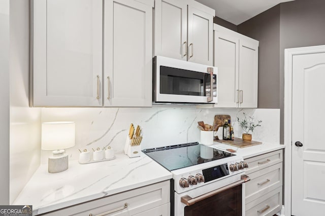 185 Starlight Dr, Dahlonega, GA 30533 - kitchen with light stone countertops, white appliances, and decorative backsplash