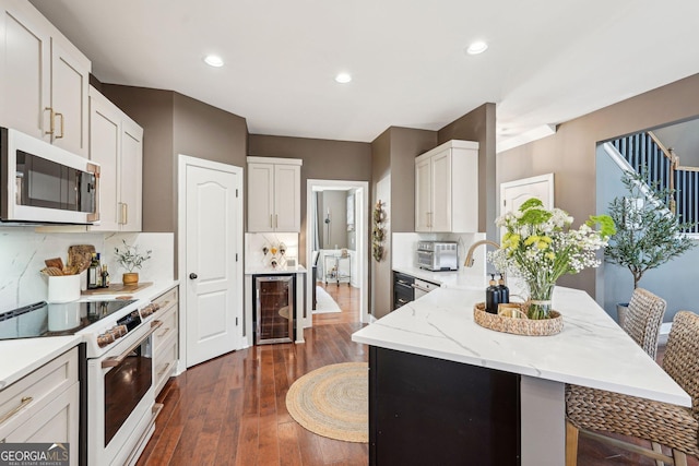 185 Starlight Dr, Dahlonega, GA 30533 - kitchen with white appliances, a peninsula, dark wood-style flooring, wine cooler, and backsplash