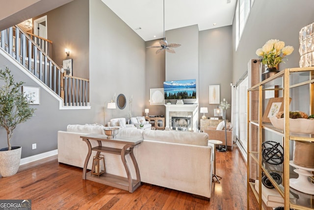 185 Starlight Dr, Dahlonega, GA 30533 - living area with baseboards, a fireplace, a high ceiling, ceiling fan, and hardwood / wood-style flooring