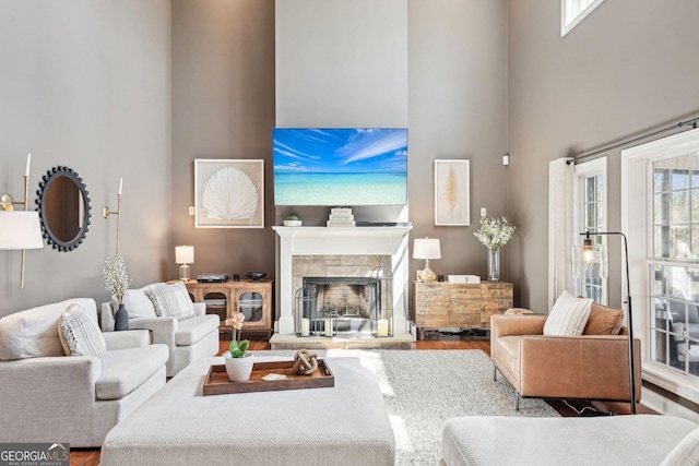 185 Starlight Dr, Dahlonega, GA 30533 - living area with a high ceiling, wood finished floors, and a stone fireplace
