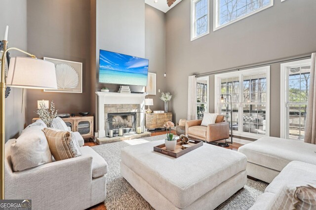 185 Starlight Dr, Dahlonega, GA 30533 - living room featuring a towering ceiling, wood finished floors, and a fireplace